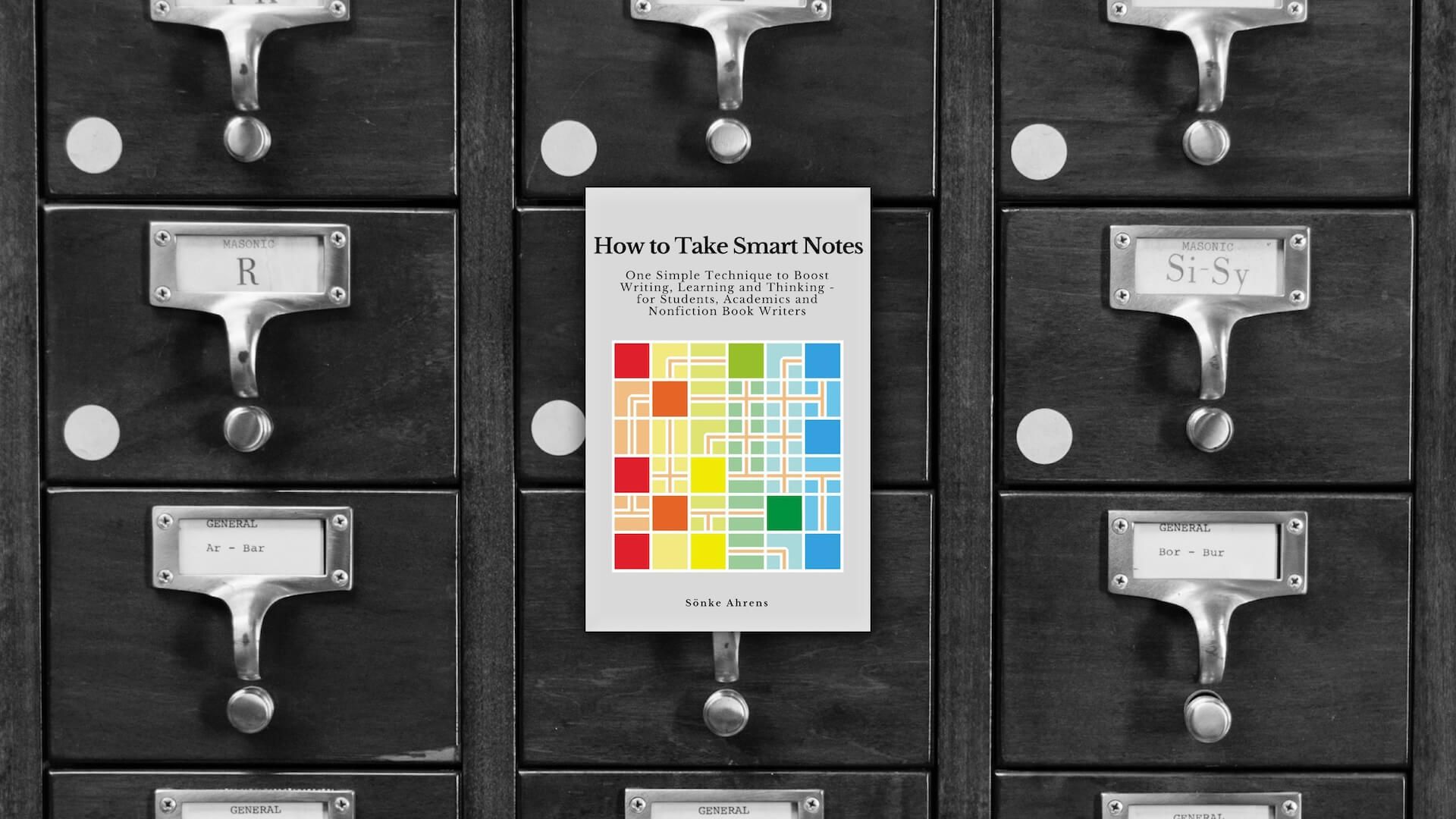 The cover of How to Take Smart Notes in front of a library book catalog.